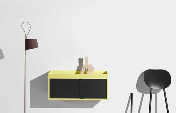 Minimalist interior with yellow floating cabinet and lamp